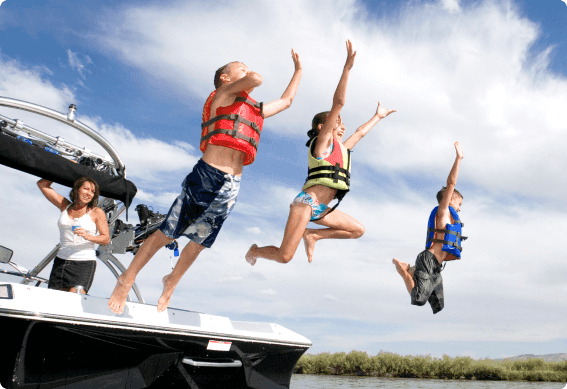 a group of people jumping off a boat