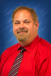 a man in a red shirt and tie