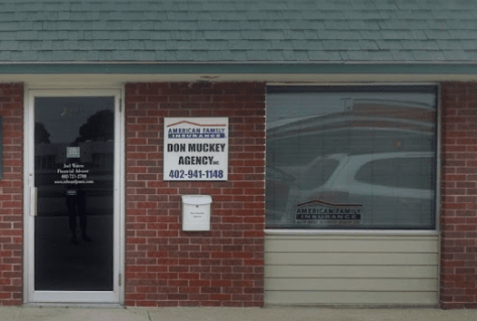 a brick building with a sign on the door