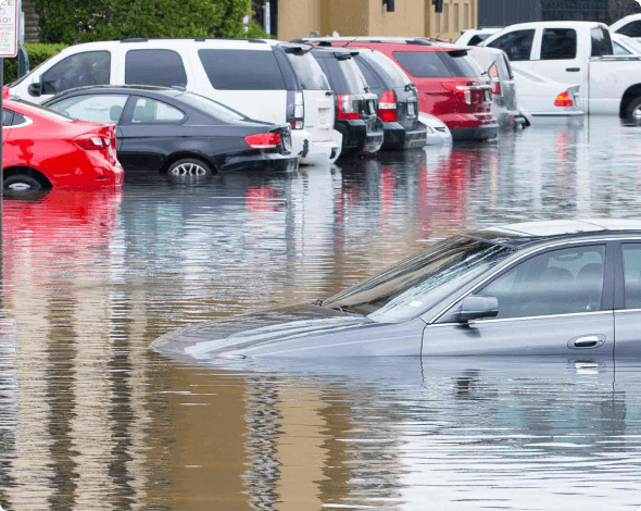 Image of parked cars flooded in a lot.