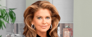 Kathy Ireland smiling in front of pictures