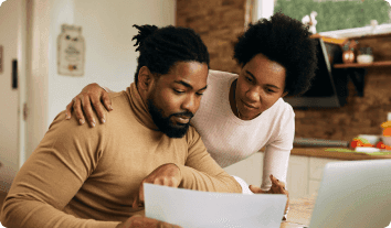 a man and a woman looking at a tablet